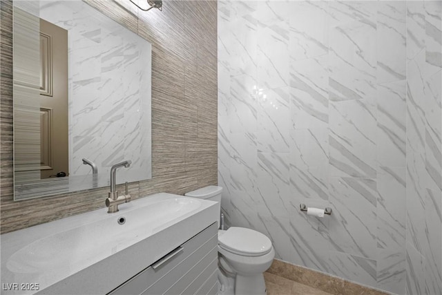 9301 Verlaine Ct, Las Vegas, NV 89145 - half bath featuring vanity, tile walls, toilet, and tile patterned flooring