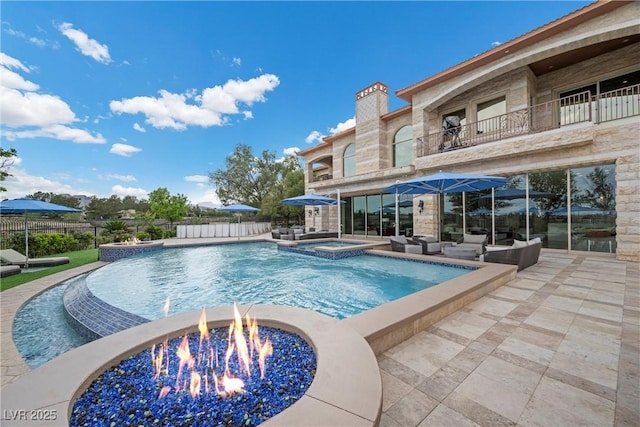 9301 Verlaine Ct, Las Vegas, NV 89145 - view of swimming pool featuring an outdoor living space with a fire pit, a patio area, fence, and a pool with connected hot tub