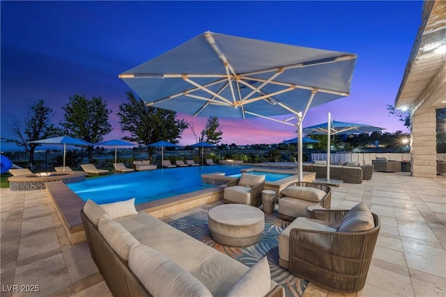 9301 Verlaine Ct, Las Vegas, NV 89145 - pool at dusk featuring a patio, an outdoor pool, and an outdoor living space