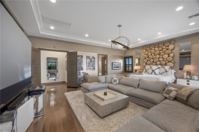 9301 Verlaine Ct, Las Vegas, NV 89145 - living room featuring a tray ceiling, wood finished floors, visible vents, and recessed lighting