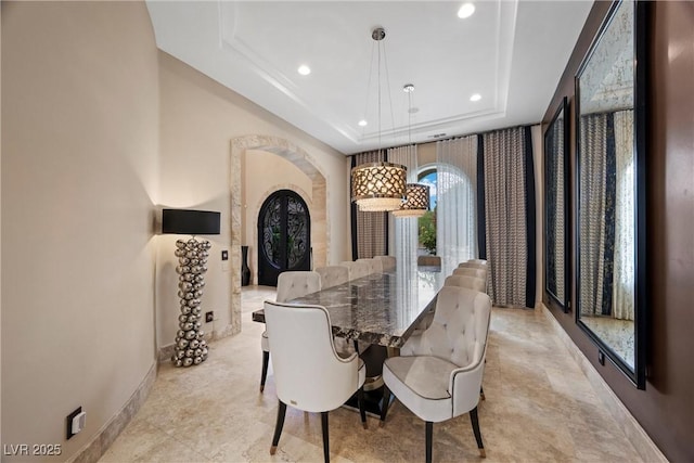 9301 Verlaine Ct, Las Vegas, NV 89145 - dining area with arched walkways, a raised ceiling, baseboards, and recessed lighting