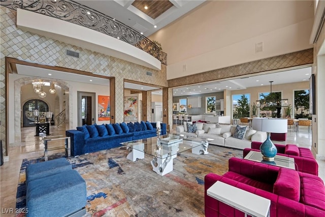 9301 Verlaine Ct, Las Vegas, NV 89145 - living room featuring visible vents, wallpapered walls, and a towering ceiling