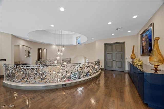 9301 Verlaine Ct, Las Vegas, NV 89145 - corridor featuring wood finished floors, visible vents, baseboards, arched walkways, and recessed lighting