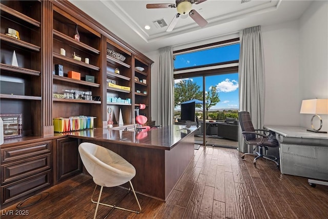 9301 Verlaine Ct, Las Vegas, NV 89145 - office area with built in desk, a tray ceiling, visible vents, ceiling fan, and dark wood-style floors