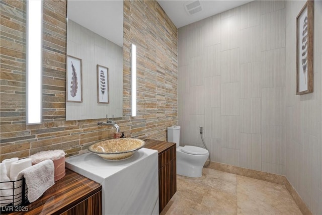9301 Verlaine Ct, Las Vegas, NV 89145 - bathroom featuring toilet, tile walls, vanity, and visible vents