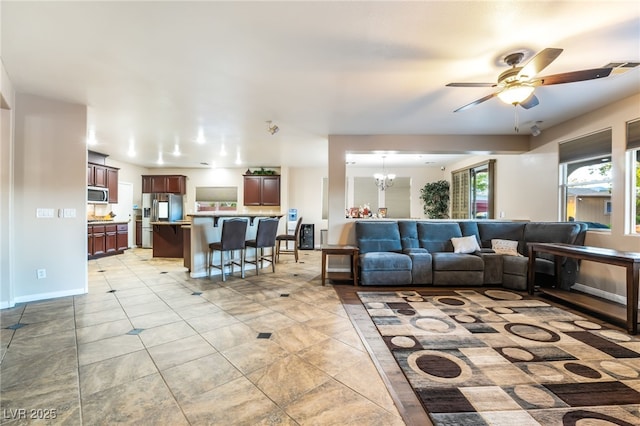 4200 Scott Peak Ct, Las Vegas, NV 89129 - living room with ceiling fan, a chandelier, and light tile patterned floors