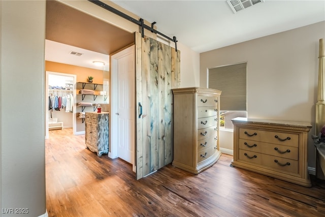 4200 Scott Peak Ct, Las Vegas, NV 89129 - bedroom featuring wood finished floors, a barn door, and a spacious closet