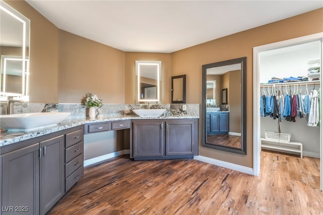 4200 Scott Peak Ct, Las Vegas, NV 89129 - full bath with double vanity, wood finished floors, a spacious closet, and baseboards