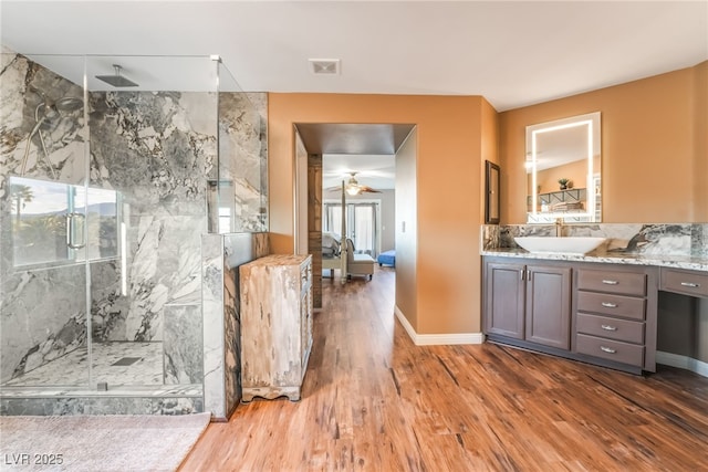 4200 Scott Peak Ct, Las Vegas, NV 89129 - bathroom featuring wood finished floors, connected bathroom, a marble finish shower, and vanity