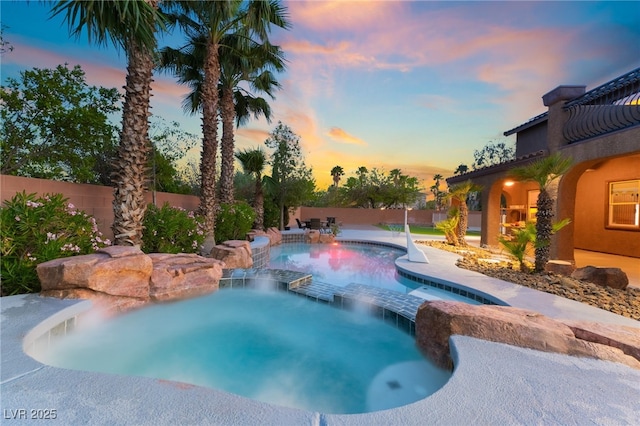 4200 Scott Peak Ct, Las Vegas, NV 89129 - pool at dusk with a pool with connected hot tub and fence