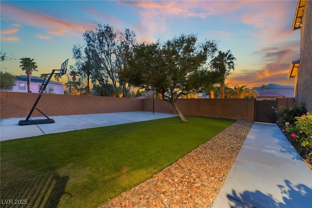 4200 Scott Peak Ct, Las Vegas, NV 89129 - yard at dusk with a patio area and a gate