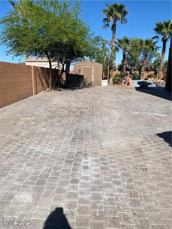 4200 Scott Peak Ct, Las Vegas, NV 89129 - view of patio with a storage shed, fence, and an outbuilding