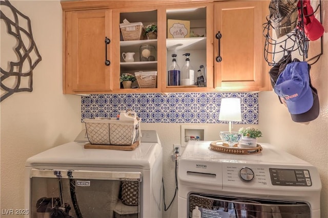 washroom featuring cabinet space and independent washer and dryer