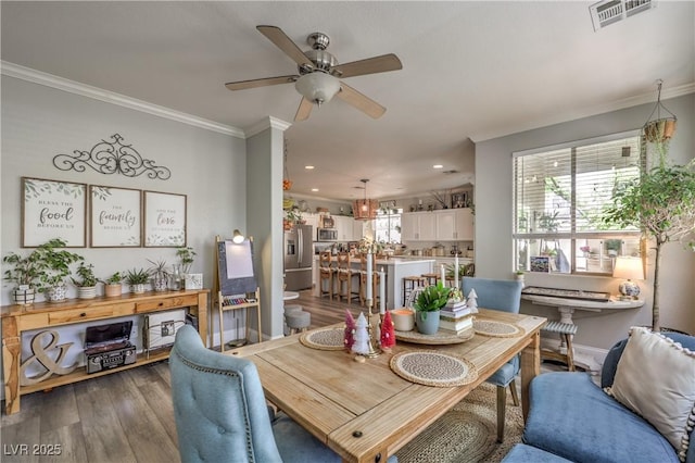dining room featuring recessed lighting, ceiling fan, visible vents, ornamental molding, and wood finished floors