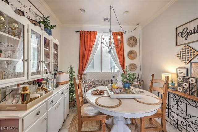 dining space with visible vents and crown molding