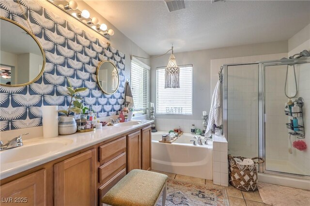 full bathroom with visible vents, a garden tub, a stall shower, and a sink