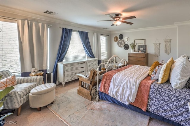 bedroom featuring visible vents, ornamental molding, and a ceiling fan