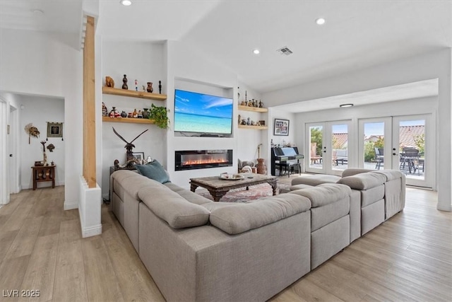 3024 Lotus Hill Dr, Las Vegas, NV 89134 - living area featuring light wood finished floors, a glass covered fireplace, recessed lighting, french doors, and baseboards