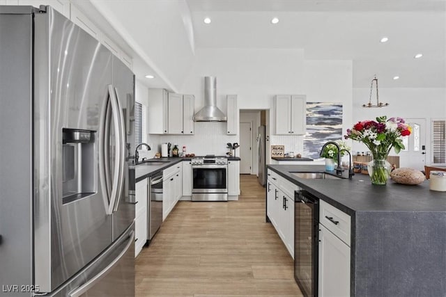 3024 Lotus Hill Dr, Las Vegas, NV 89134 - kitchen featuring appliances with stainless steel finishes, a sink, wall chimney range hood, dark countertops, and recessed lighting