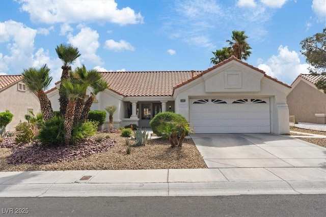 3024 Lotus Hill Dr, Las Vegas, NV 89134 - mediterranean / spanish-style house with a tile roof, an attached garage, driveway, and stucco siding