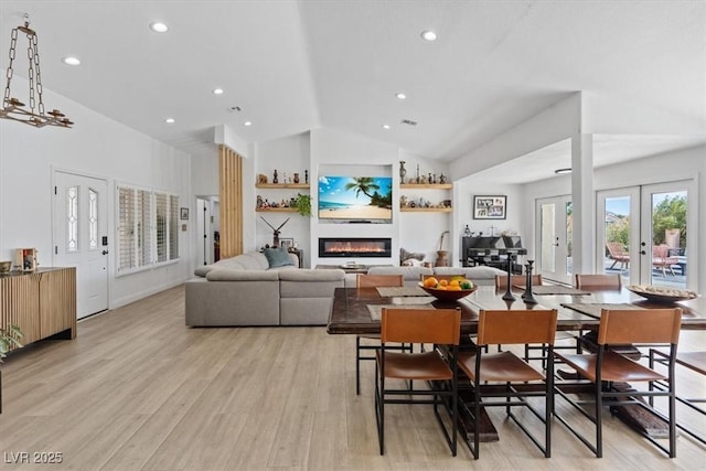 3024 Lotus Hill Dr, Las Vegas, NV 89134 - dining space featuring a glass covered fireplace, lofted ceiling, french doors, light wood finished floors, and recessed lighting