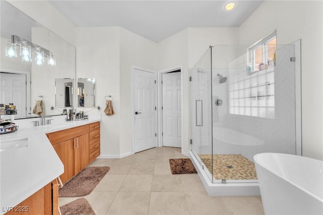 465 Indigo Springs St, Henderson, NV 89014 - full bathroom with double vanity, a freestanding bath, tile patterned floors, and a stall shower