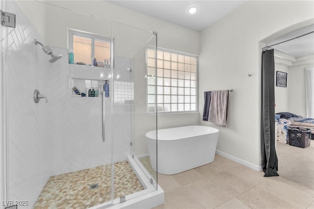 465 Indigo Springs St, Henderson, NV 89014 - full bathroom featuring baseboards, a freestanding tub, tile patterned floors, and a stall shower