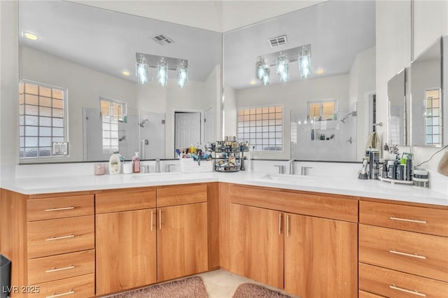 465 Indigo Springs St, Henderson, NV 89014 - bathroom with visible vents, a sink, a stall shower, and double vanity