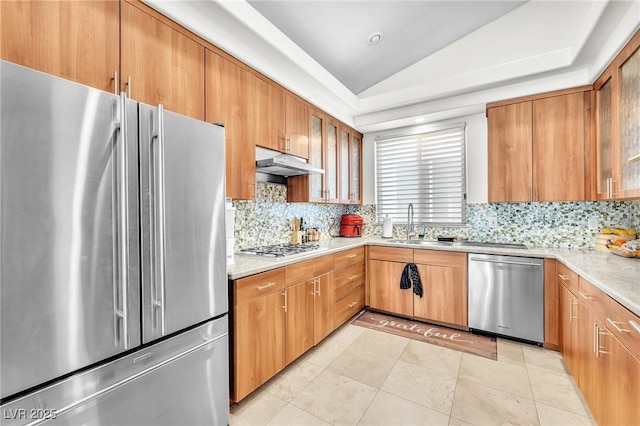 465 Indigo Springs St, Henderson, NV 89014 - kitchen featuring decorative backsplash, lofted ceiling, under cabinet range hood, a sink, and appliances with stainless steel finishes