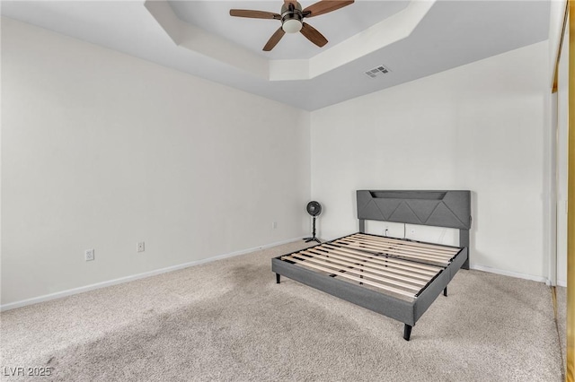 465 Indigo Springs St, Henderson, NV 89014 - unfurnished bedroom featuring carpet floors, a tray ceiling, visible vents, and baseboards
