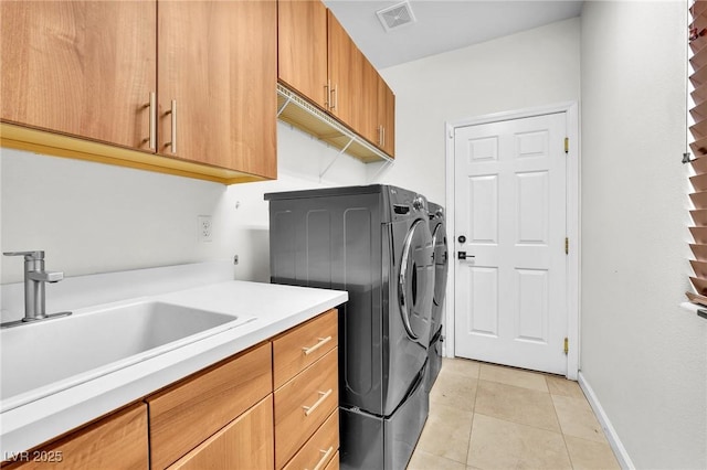 465 Indigo Springs St, Henderson, NV 89014 - washroom with visible vents, cabinet space, a sink, light tile patterned floors, and separate washer and dryer