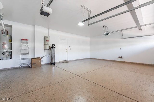 7526 Gossamer Wind St, Las Vegas, NV 89139 - garage with a garage door opener, strapped water heater, a central vacuum unit, and baseboards
