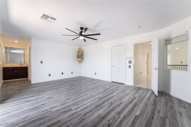 7526 Gossamer Wind St, Las Vegas, NV 89139 - unfurnished living room featuring a ceiling fan, wood finished floors, and baseboards