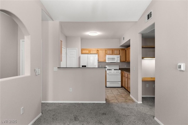 10001 Peace Way Unit 2228, Las Vegas, NV 89147 - kitchen featuring white appliances, light carpet, baseboards, arched walkways, and a peninsula