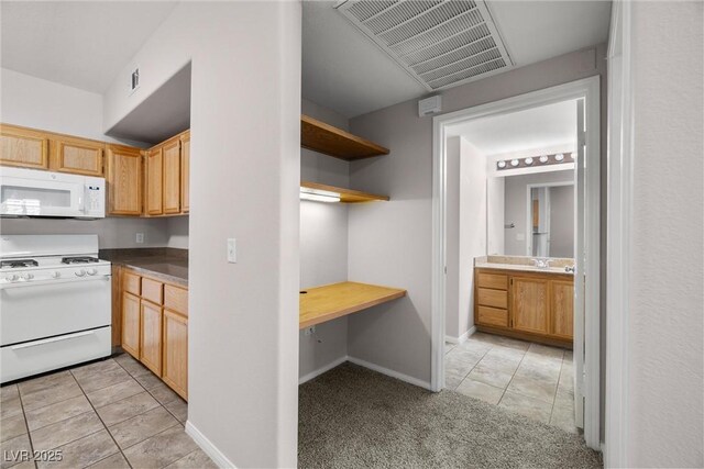 10001 Peace Way Unit 2228, Las Vegas, NV 89147 - kitchen featuring white appliances, light tile patterned flooring, open shelves, a sink, and light carpet