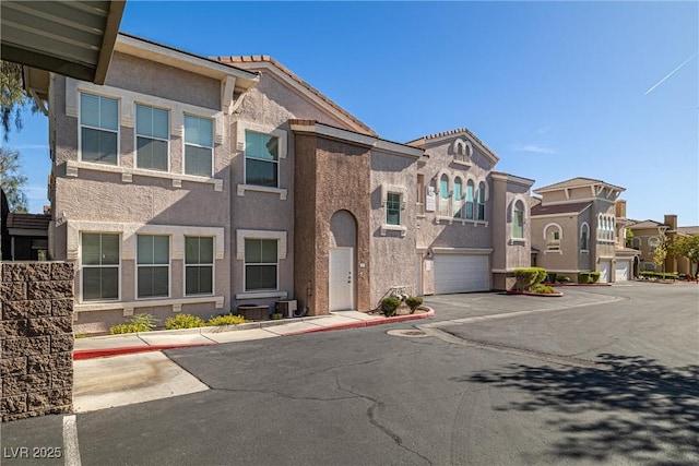 10001 Peace Way Unit 2228, Las Vegas, NV 89147 - view of front of property with stucco siding, an attached garage, driveway, and a residential view