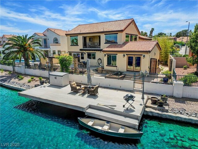 2708 Port Of Call Dr, Las Vegas, NV 89128 - rear view of property featuring a tile roof, a wooden deck, stucco siding, french doors, and a pool