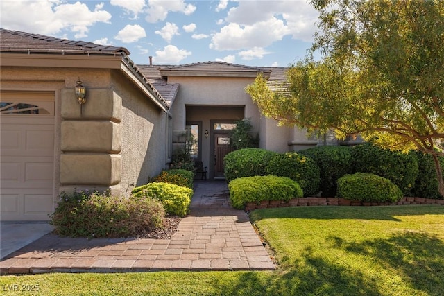 240 Jumping Springs Pl, Henderson, NV 89012 - entrance to property featuring an attached garage, a tiled roof, a lawn, and stucco siding