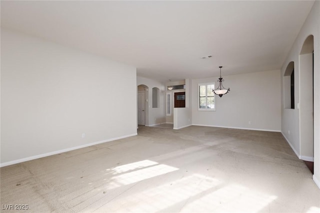 240 Jumping Springs Pl, Henderson, NV 89012 - unfurnished room featuring arched walkways, light colored carpet, and baseboards
