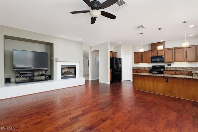 240 Jumping Springs Pl, Henderson, NV 89012 - kitchen with black appliances, open floor plan, brown cabinets, dark wood-style flooring, and a ceiling fan