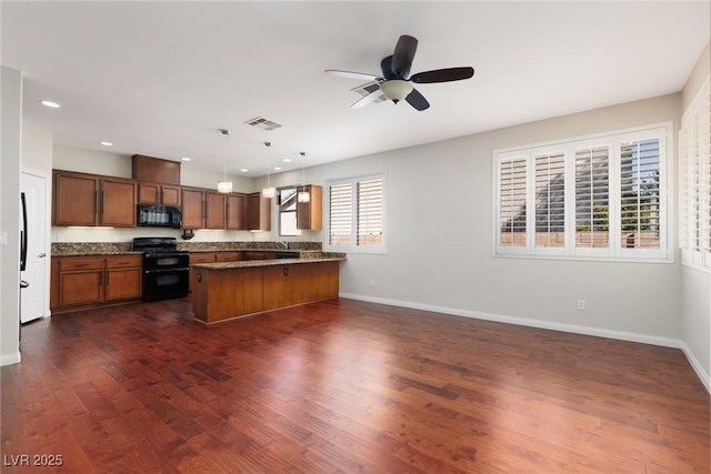 240 Jumping Springs Pl, Henderson, NV 89012 - kitchen featuring black appliances, dark countertops, baseboards, brown cabinetry, and recessed lighting