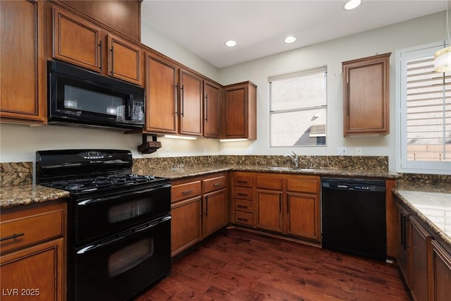 240 Jumping Springs Pl, Henderson, NV 89012 - kitchen with black appliances, a sink, dark wood-type flooring, recessed lighting, and brown cabinets