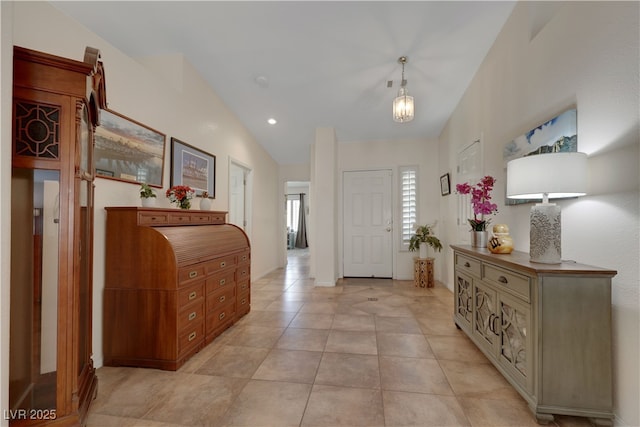 foyer with recessed lighting, light tile patterned floors, and vaulted ceiling