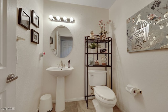 bathroom featuring toilet and a sink