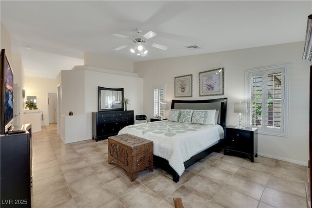 bedroom featuring vaulted ceiling, baseboards, visible vents, a ceiling fan, and light tile patterned flooring