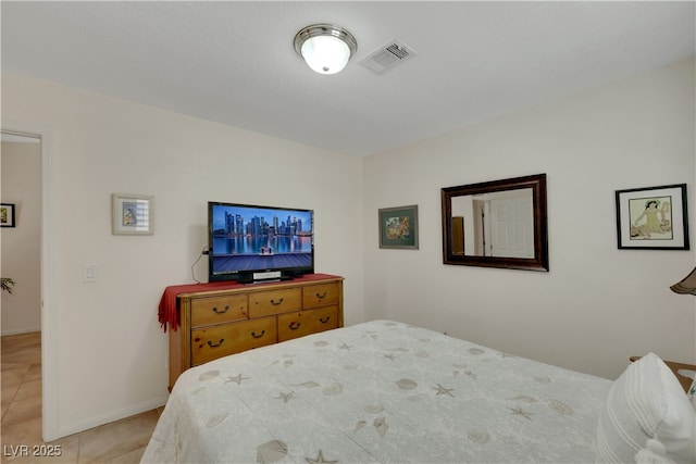 bedroom with light tile patterned flooring, visible vents, and baseboards