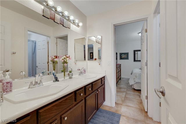 ensuite bathroom featuring double vanity, ensuite bath, tile patterned flooring, and a sink