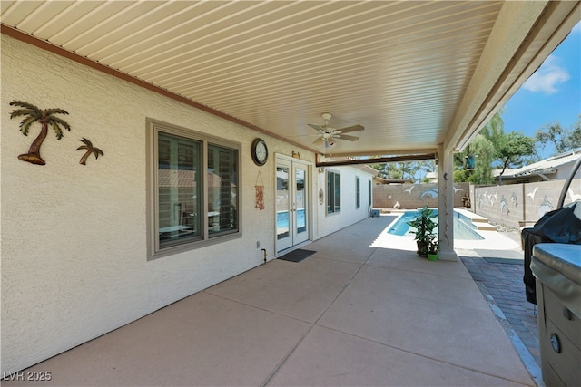 view of patio / terrace with french doors, a fenced backyard, a ceiling fan, and a fenced in pool