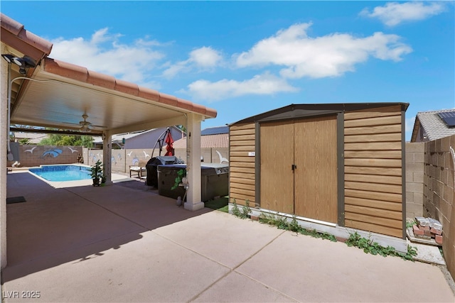 view of shed with a fenced in pool and a fenced backyard