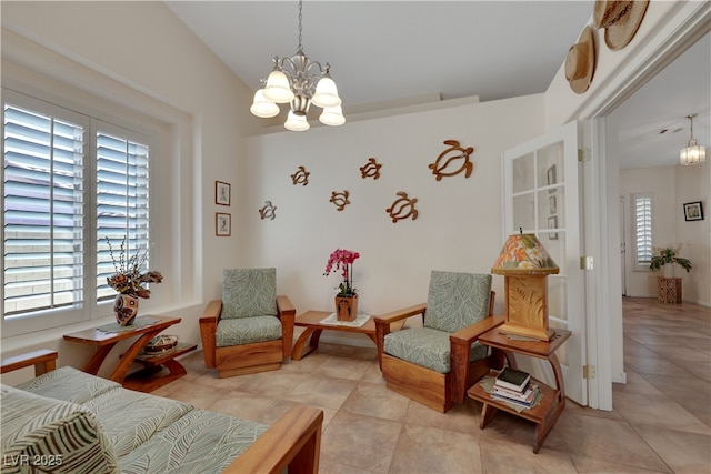 living area with a healthy amount of sunlight, a notable chandelier, and light tile patterned flooring
